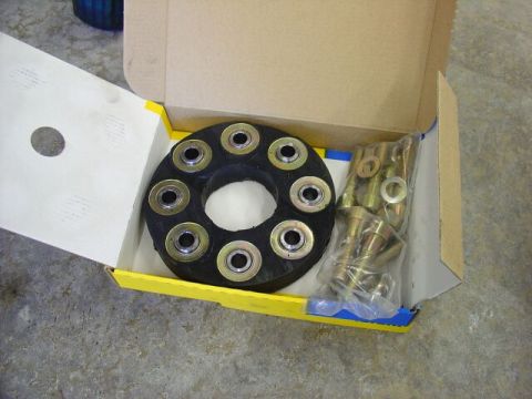 1984 Ford Bronco - A driveshaft flex disc and associated hardware are shown inside a cardboard box.