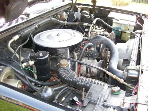 1984 Ford Bronco - The engine bay of a vehicle, the air cleaner assembly labeled '5.8 Liter'.