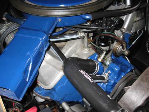 1968 Shelby GT500 - Close-up view of a 1968 Shelby GT500 engine, highlighting its blue painted parts and various hoses.
