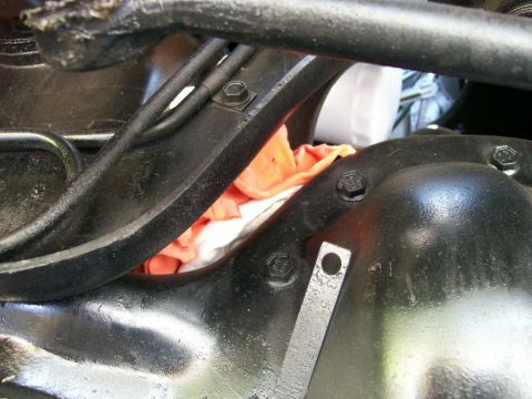 1984 Ford Bronco - This image shows a close-up view of a vehicle's rear differential assembly, with some mechanical components and a tag visible.