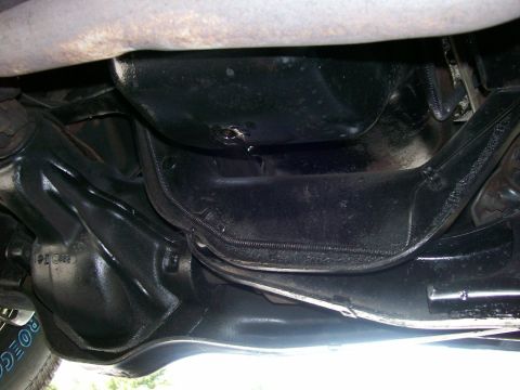 1984 Ford Bronco - This photo shows the underside of a vehicle, focusing on the engine oil pan and exhaust system.