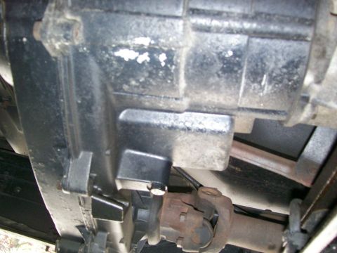 1984 Ford Bronco - Close-up of the transfer case and driveshaft, showing mechanical components of the drivetrain.