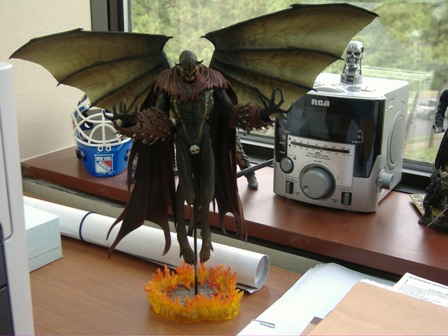 1991 Ford Bronco - An action figure with wings is displayed on a desk next to a radio and a hockey mask.