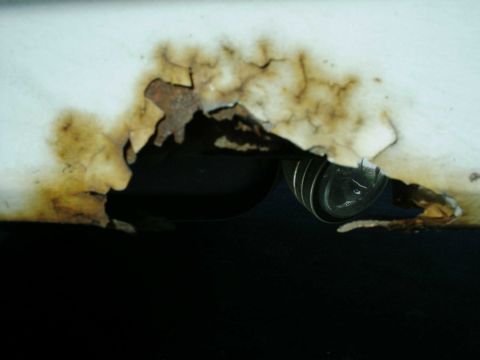 1988 Ford Bronco - Significant rust damage is visible on this white panel, exposing corroded metal.