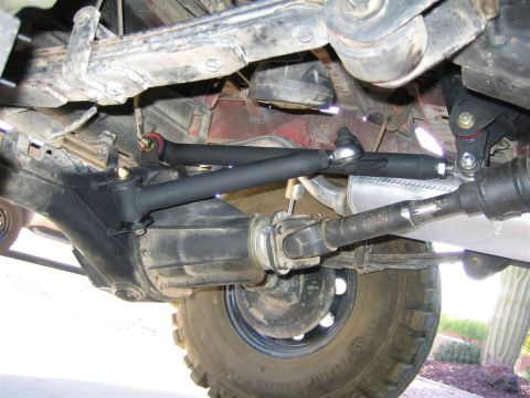 1987 Suzuki Samurai - Close-up view of the undercarriage, focusing on the suspension system and drivetrain components.