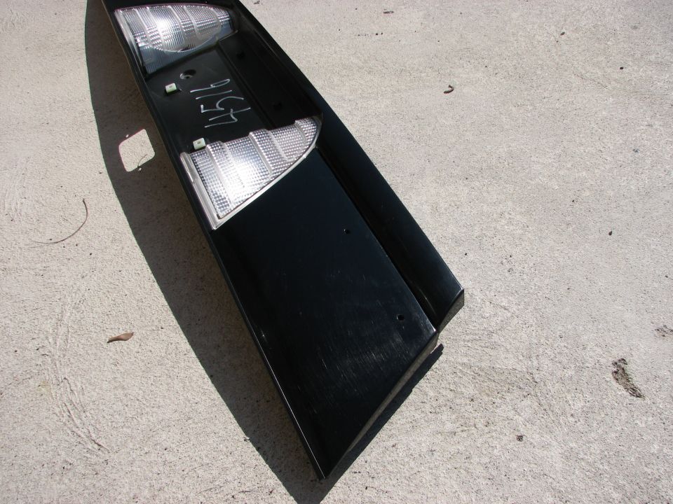 Black car tail light assembly with clear lenses, marked with '4516'