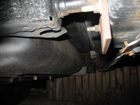 1985 Ford LTD Crown Victoria - Close-up view of the underside of a vehicle, showing the fuel tank and frame structure.