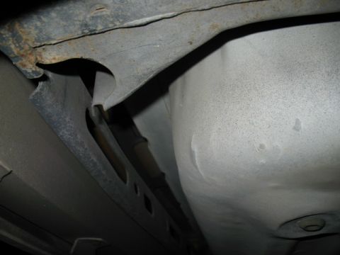 1985 Ford LTD Crown Victoria - Underside view of the vehicle's chassis, showing structural components and signs of rust.