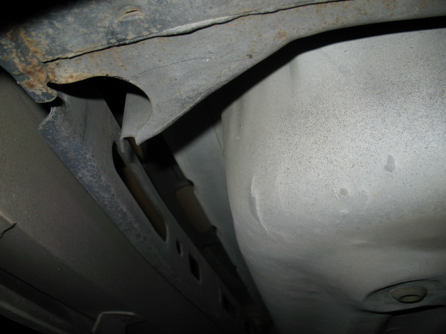 Underbody chassis with rust and suspension components visible