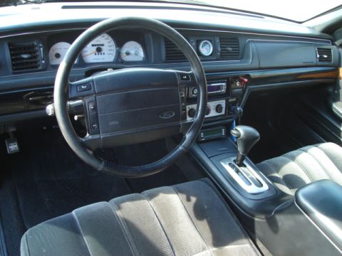 1992 Ford Crown Victoria - The interior of a 1992 Ford Crown Victoria, showing the dashboard, steering wheel, and center console.