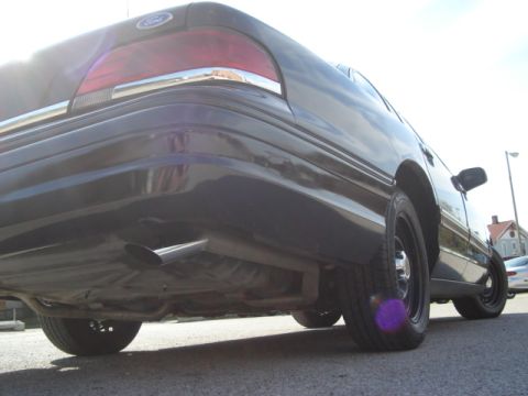 1992 Ford Crown Victoria - Rear view of a 1992 Ford Crown Victoria, showing the quarter panel, exhaust, and wheel.