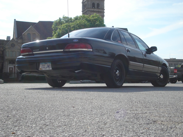 1992 Ford Crown Victoria rear view, black paint, steel wheels, license plate 721 JWL
