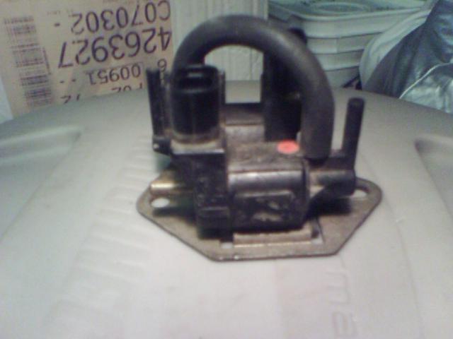 Black automotive part with hoses and mounting bracket, part number 4263927 visible