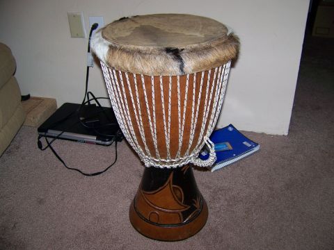 1995 Ford Bronco - A djembe drum is shown indoors, placed on a carpeted floor.
