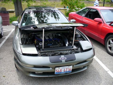 1991 Ford Probe - A silver 1991 Ford Probe is parked with its hood open, revealing the engine bay, next to a red Ford Probe.