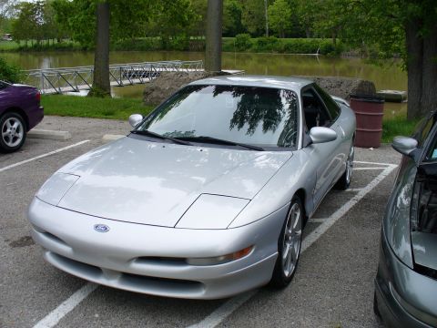 1991 Ford Probe - A silver 1991 Ford Probe is parked outdoors near a body of water.