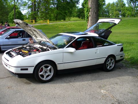 1991 Ford Probe - White 1991 Ford Probe with its hood and trunk open, parked at an outdoor gathering.