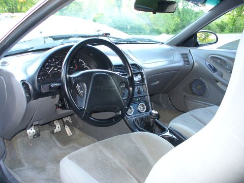 1991 Ford Probe - The interior of a 1991 Ford Probe is visible, including the dashboard and seats.