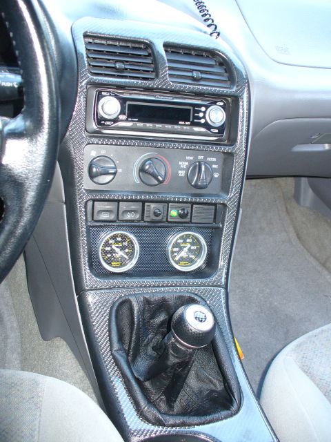 1991 Ford Probe - Interior view of a 1991 Ford Probe, aftermarket gauges and carbon fiber trim on the center console.