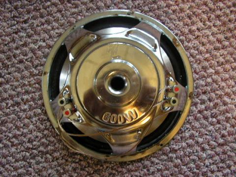 1994 Ford Probe - A car audio subwoofer with visible wattage marking is shown against a carpeted background.