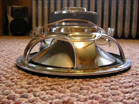 1994 Ford Probe - A speaker with a chrome basket and black cone is shown resting on a carpeted surface.