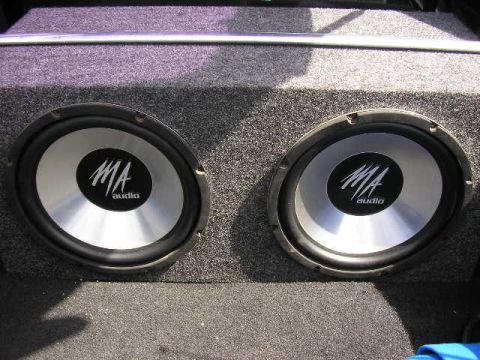 1994 Ford Probe - Two MA audio subwoofers are visible in a carpeted enclosure, likely installed in the trunk of a car.