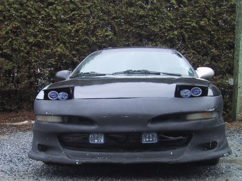 1993 Ford Probe - Front view of a black 1993 Ford Probe with custom body modifications and aftermarket lighting.