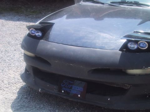 1993 Ford Probe - The front of a 1993 Ford Probe is shown, its distinctive pop-up headlights and a license plate frame.