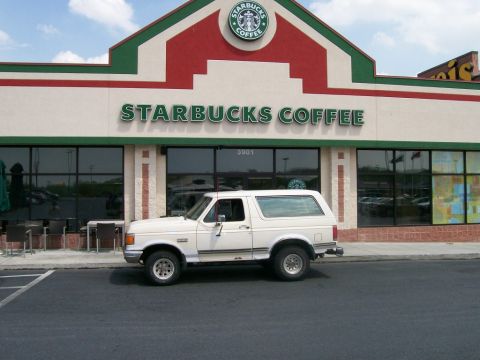 1988 Ford Bronco - A white 1987 Ford Bronco is parked in front of a Starbucks coffee shop.