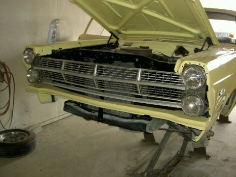 1967 Ford Ranchero - Front view of a 1967 Ford Ranchero undergoing repairs, hood is open.