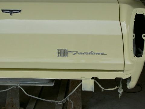1967 Ford Ranchero - Close-up of the rear quarter panel of a Ford Fairlane, showing the model designation and a missing tail light assembly.