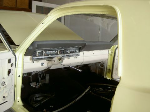 1967 Ford Ranchero - The dashboard and interior of a classic car are visible, with the driver's side door open.