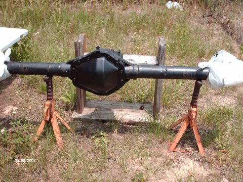 1982 Ford F-100 - Rear axle assembly displayed on jack stands in a grassy outdoor area.
