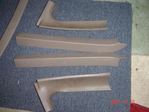 1993 Ford Bronco - Various interior trim pieces are shown on a carpeted surface, likely for a vehicle.
