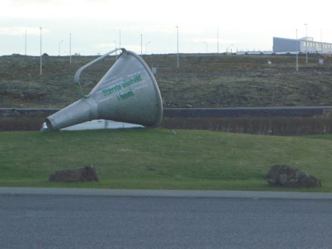 1974 Ford Bronco - A large metal funnel sculpture is visible on a grassy hill with a building in the background.