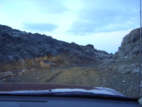 1974 Ford Bronco - Driving through a , rocky landscape under a cloudy sky.