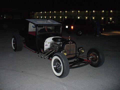 1991 Ford Probe - A custom hot rod sits parked at night, with another vehicle and building in the background.