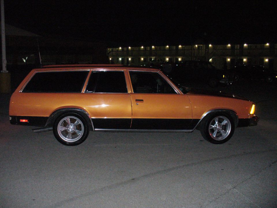 Orange and black station wagon, side view