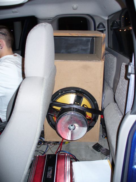 1991 Ford Probe - Custom car audio setup with a large subwoofer and amplifier installed in the rear interior.