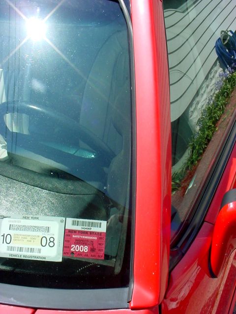 2000 Ford Taurus - Interior view of a red car, New York registration and inspection stickers, one expiring in 2008.