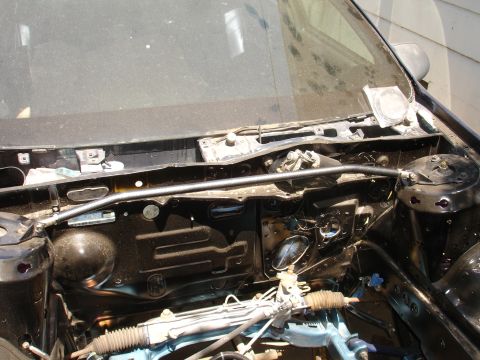 1992 Ford Taurus - The engine bay of a car shows a strut bar and steering rack, with no visible year identification.