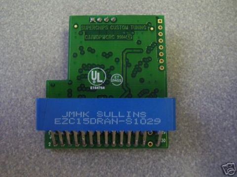 2003 Ford Crown Victoria - Electronic tuning chip with 'SUPERCHIPS CUSTOM TUNING' and '2004' visible.