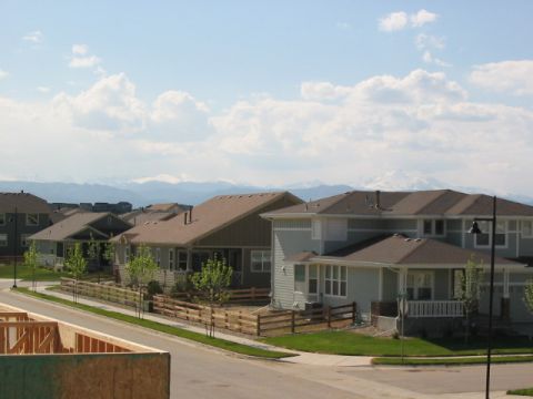 1995 Ford Bronco - A view of a suburban neighborhood with houses and mountains in the distance.