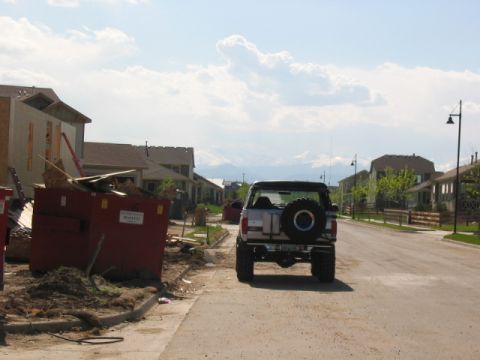 1995 Ford Bronco - A 1995 Ford Bronco is parked on a street in a neighborhood with new homes being built.