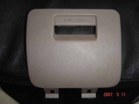 1993 Ford Bronco - Close-up of a vehicle's fuse panel cover, showing embossed text.