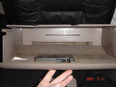 1993 Ford Bronco - The interior of a vehicle's glove box is shown, empty except for a latch.