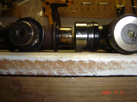 1993 Ford Bronco - Close-up of two driveshaft universal joints, one showing signs of rust and wear, the other appearing newer.