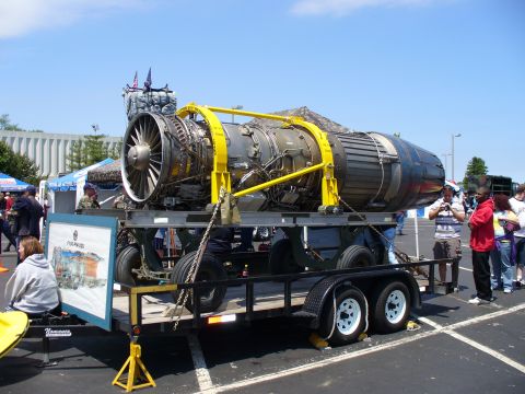1991 Ford Probe - A large jet engine is displayed on a trailer at an outdoor event.