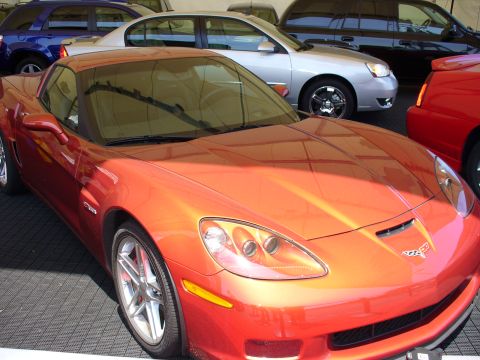 1991 Ford Probe - An orange sports car is parked in front of other vehicles, with a watermark at the bottom right.
