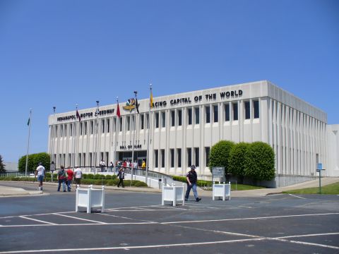 1991 Ford Probe - The Indianapolis Motor Speedway Hall of Fame building is seen under a clear blue sky.